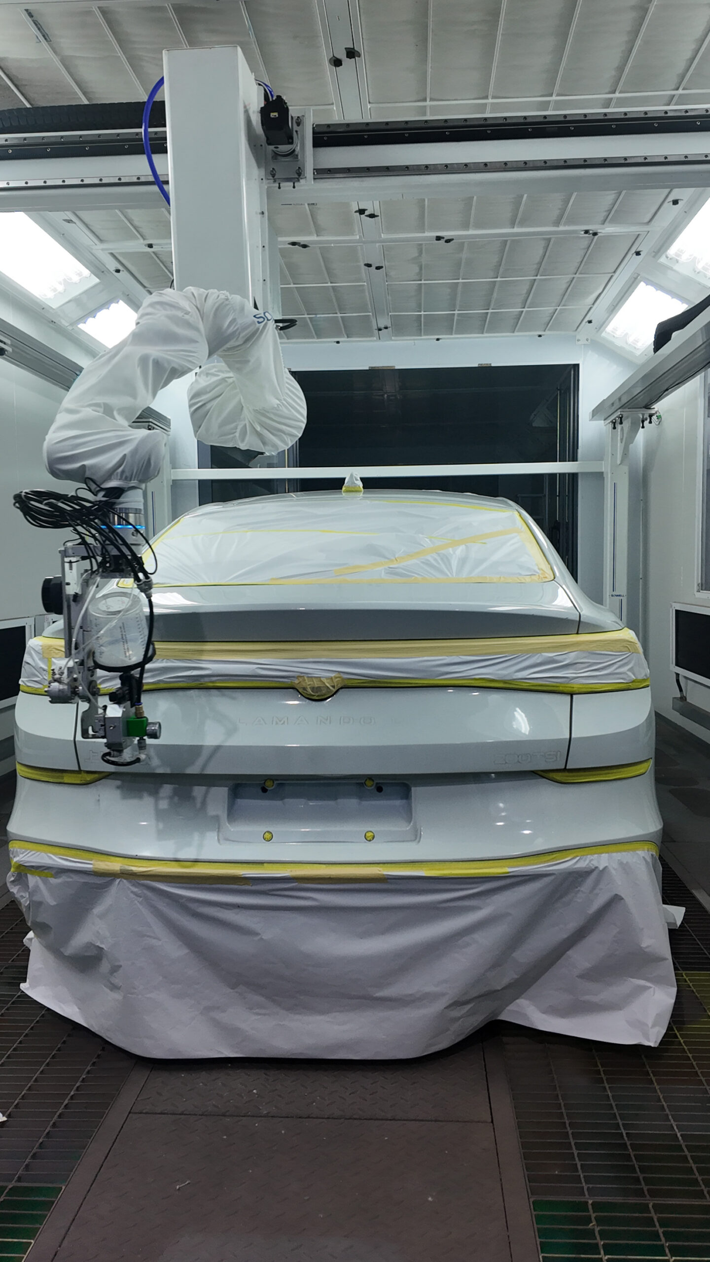 ROWBOT arm spraying the rear of a car